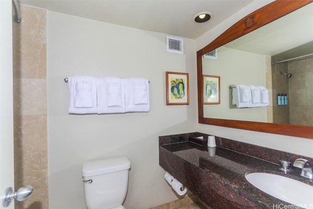 full bath featuring toilet, a shower, a sink, and visible vents