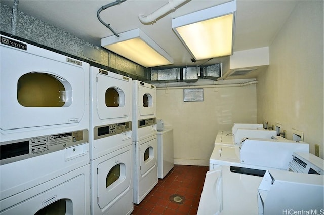 shared laundry area with stacked washer and dryer and washing machine and dryer