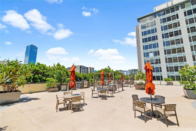 view of community with a patio area and a view of city