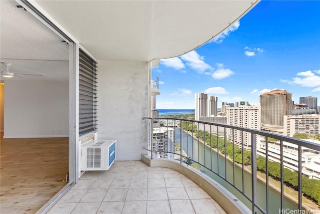 balcony featuring a view of city and a water view