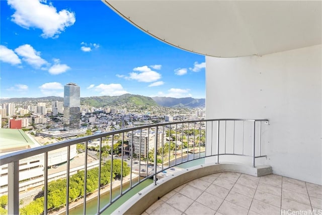 balcony with a view of city and a mountain view