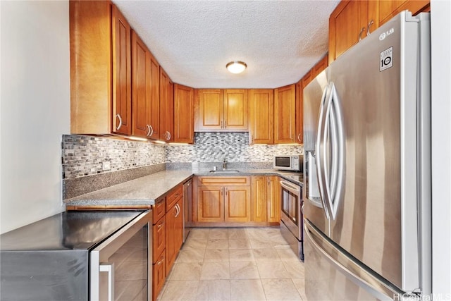 kitchen featuring stainless steel appliances, brown cabinetry, and decorative backsplash