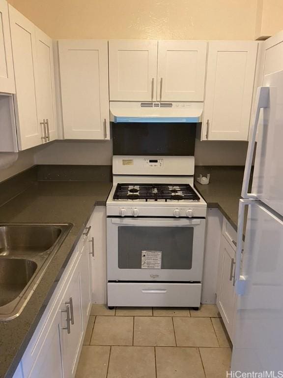 kitchen featuring white cabinets, under cabinet range hood, white appliances, and a sink