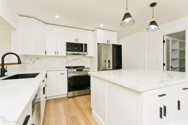 219 Loko Pl, Wahiawa, HI 96786 - kitchen featuring backsplash, light wood finished floors, appliances with stainless steel finishes, and a sink