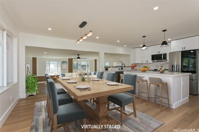 dining space with light wood-style floors, recessed lighting, baseboards, and a ceiling fan