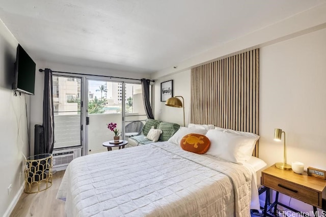 bedroom with light wood finished floors and baseboards