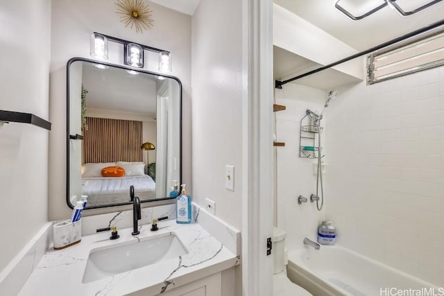 ensuite bathroom with bathtub / shower combination, vanity, and ensuite bathroom