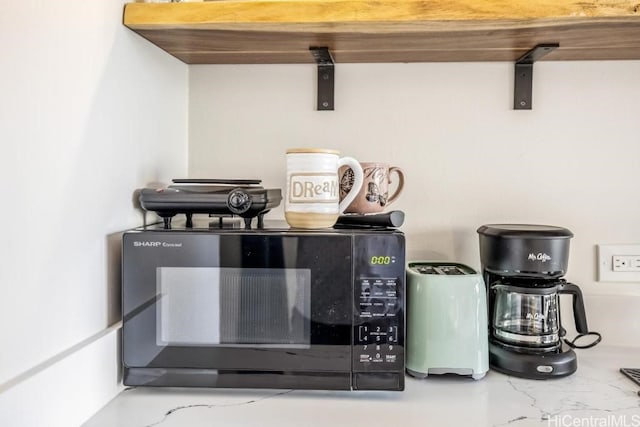 details with light stone counters and black microwave