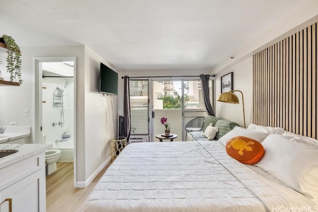 bedroom featuring ensuite bathroom, access to outside, light wood-type flooring, and baseboards