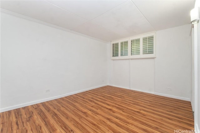 unfurnished room with wood finished floors and baseboards