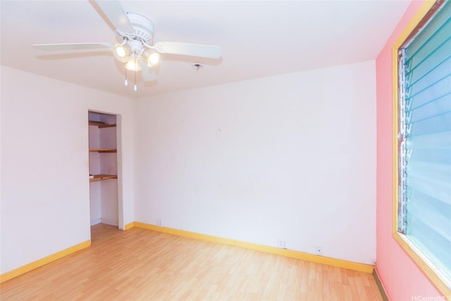 unfurnished room with ceiling fan, baseboards, and wood finished floors
