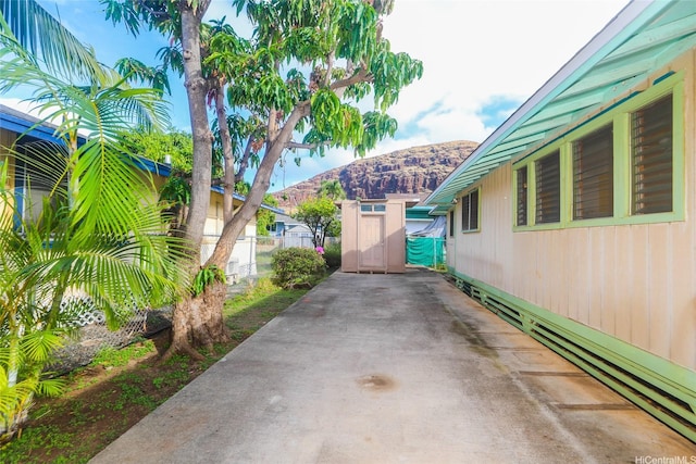 view of patio featuring fence and a mountain view