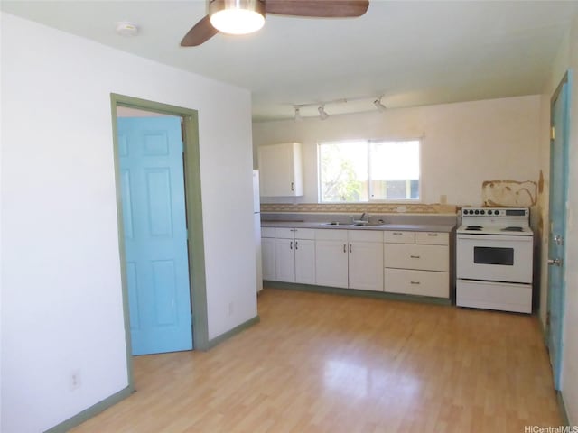 kitchen with white appliances, a ceiling fan, white cabinets, a sink, and light wood finished floors