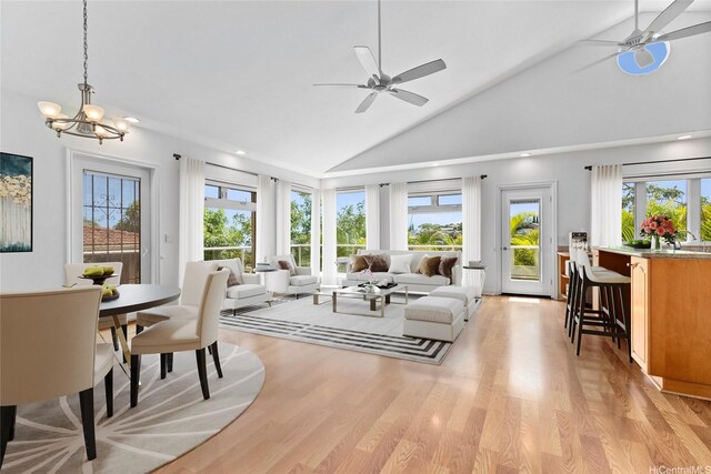 92-1277 Hauone St, Kapolei, HI 96707 - living room featuring a ceiling fan, plenty of natural light, light wood-style floors, high vaulted ceiling, and a chandelier
