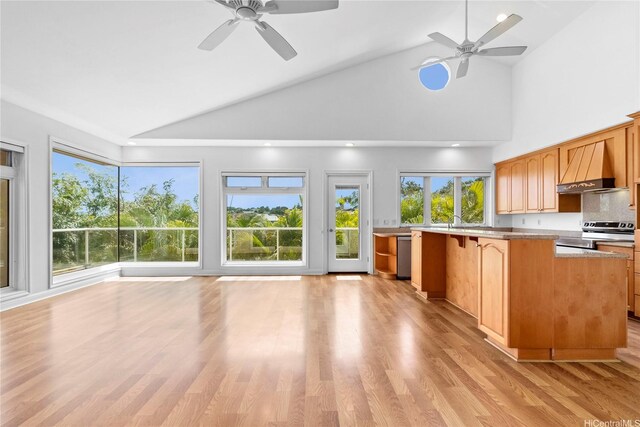 92-1277 Hauone St, Kapolei, HI 96707 - kitchen with wall chimney range hood, a ceiling fan, appliances with stainless steel finishes, light countertops, and light wood finished floors