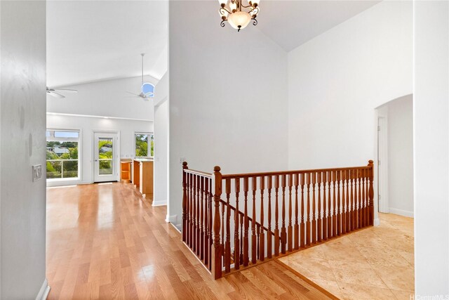 92-1277 Hauone St, Kapolei, HI 96707 - hallway with an upstairs landing, high vaulted ceiling, arched walkways, and wood finished floors