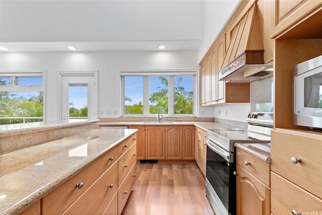 92-1277 Hauone St, Kapolei, HI 96707 - kitchen with appliances with stainless steel finishes, custom exhaust hood, light wood-type flooring, light stone countertops, and light brown cabinetry