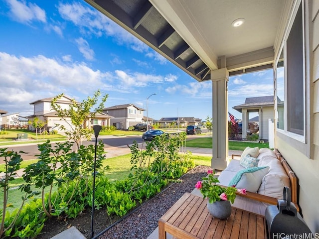 view of yard with a porch and a residential view