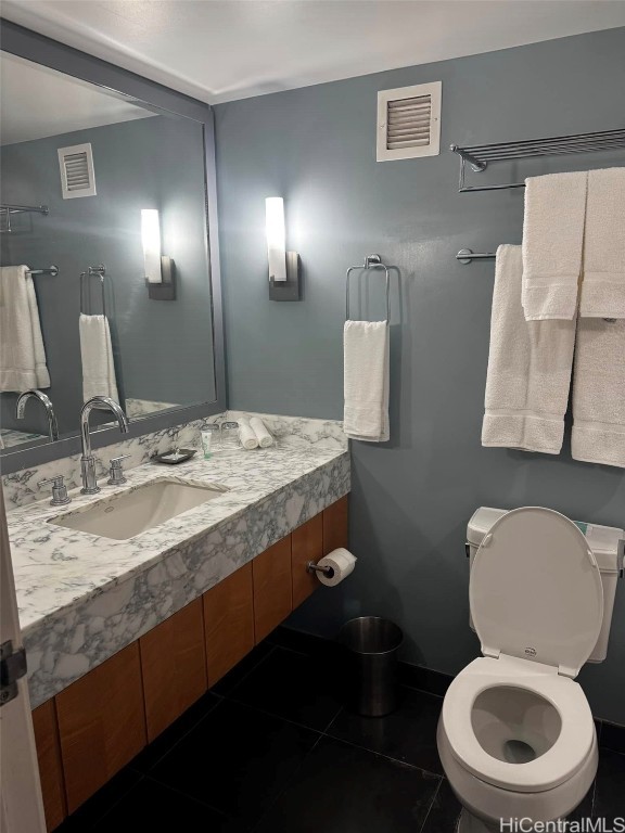 bathroom featuring visible vents, toilet, and vanity