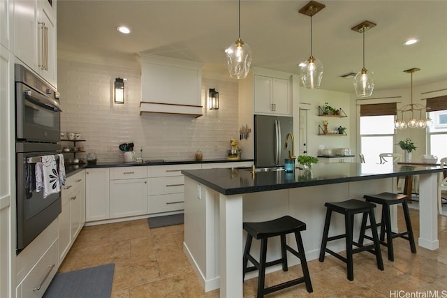 kitchen featuring dobule oven black, visible vents, stainless steel refrigerator with ice dispenser, backsplash, and dark countertops