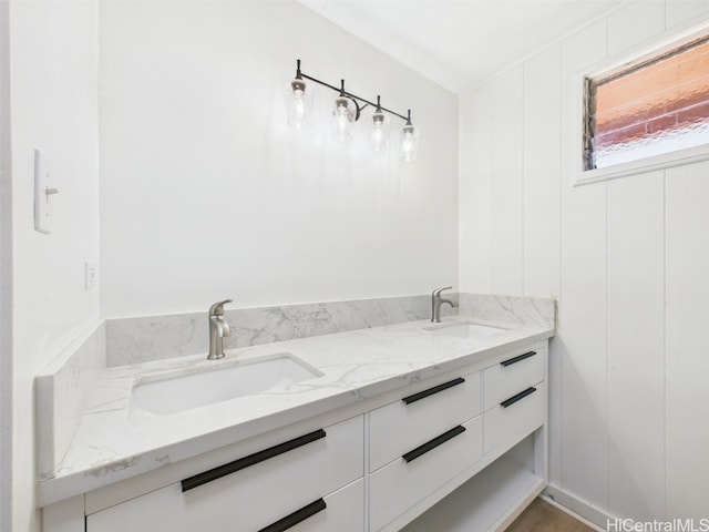 bathroom with double vanity and a sink