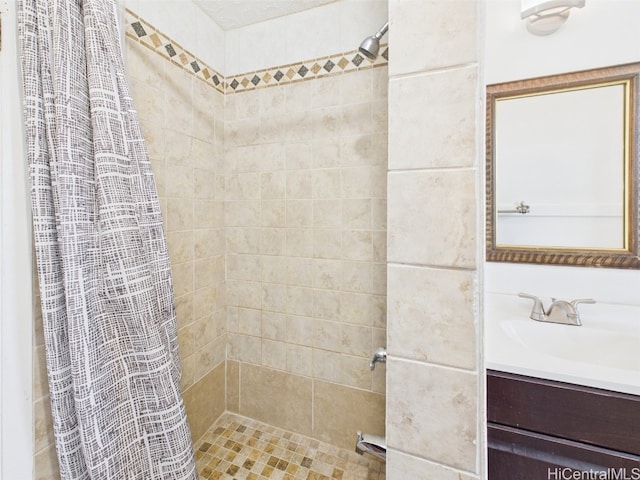 full bathroom with tiled shower and vanity