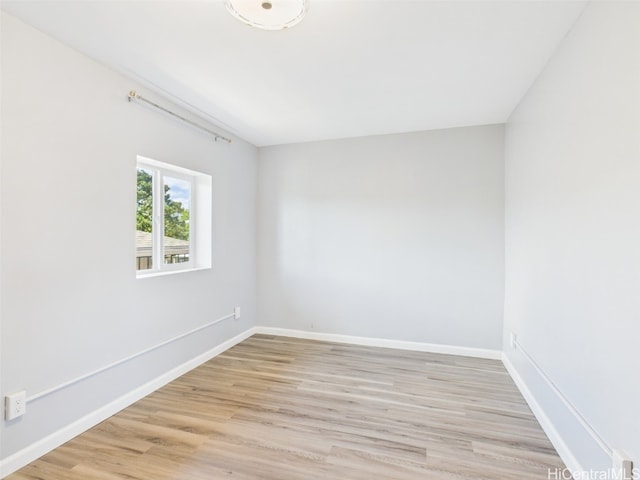 unfurnished room with baseboards and light wood finished floors