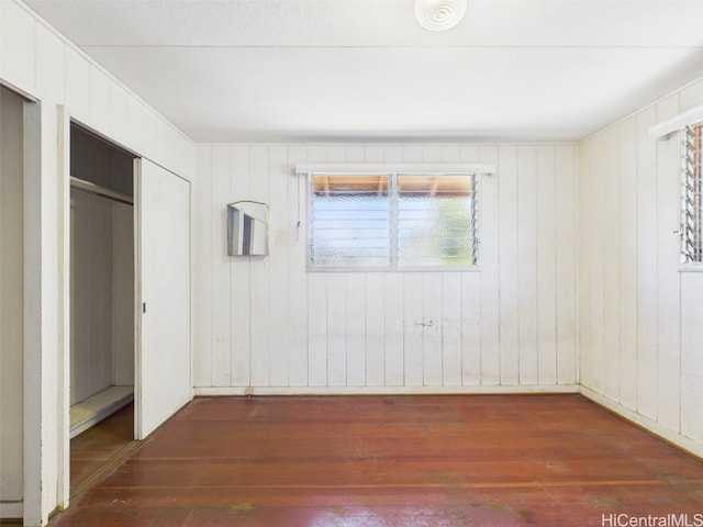 unfurnished bedroom with a closet and wood finished floors