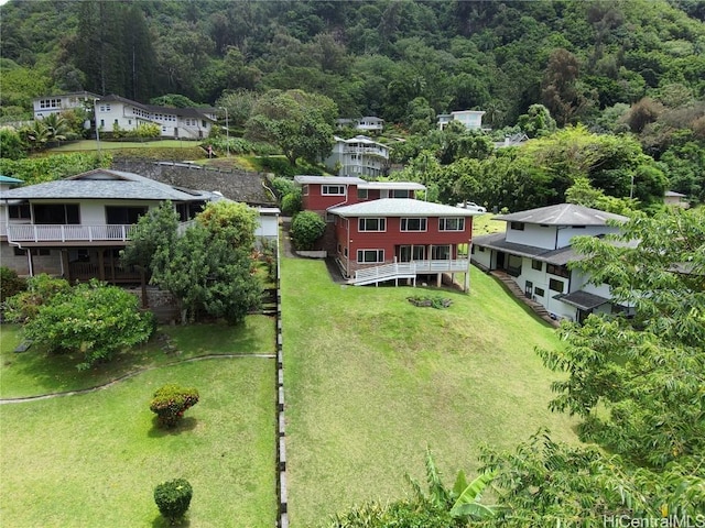 drone / aerial view featuring a wooded view