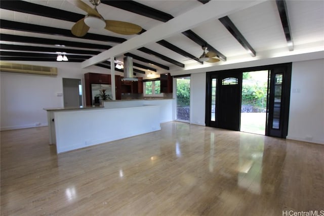 entrance foyer featuring a ceiling fan, light wood-type flooring, and lofted ceiling with beams