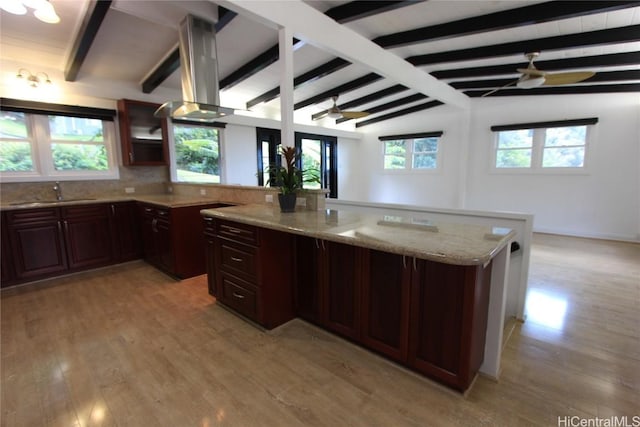 kitchen featuring ceiling fan, light wood-type flooring, plenty of natural light, and a sink