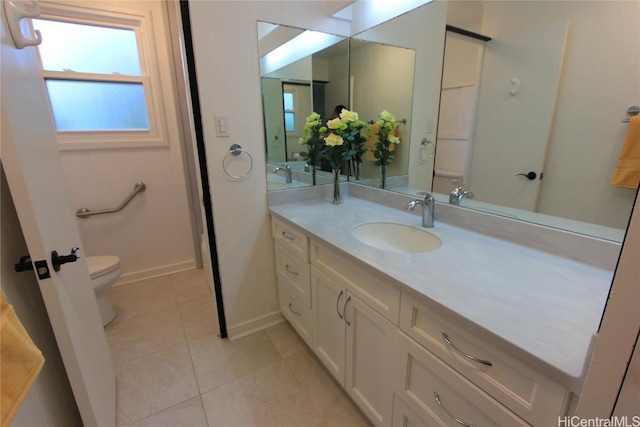 bathroom featuring toilet, baseboards, vanity, and tile patterned floors