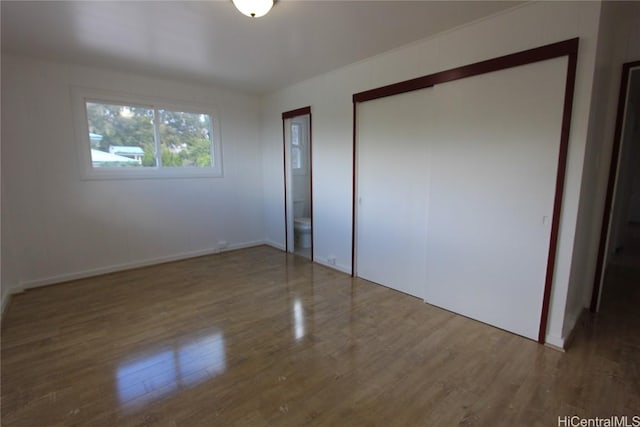 unfurnished bedroom with wood finished floors