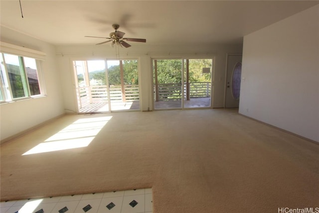 empty room featuring light carpet and ceiling fan