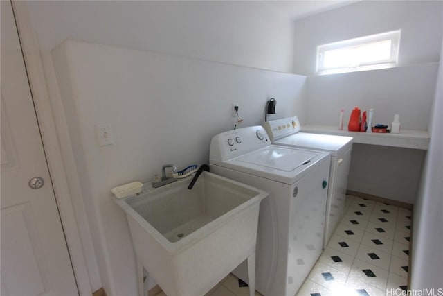 laundry room featuring laundry area, washer and clothes dryer, and a sink