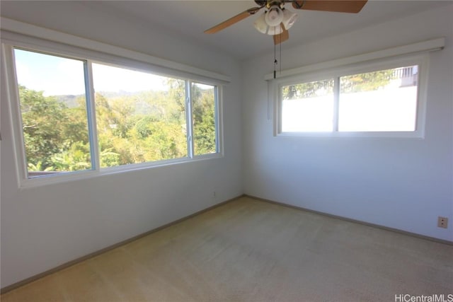 empty room with ceiling fan and light colored carpet