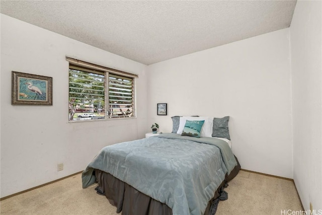 carpeted bedroom with a textured ceiling and baseboards