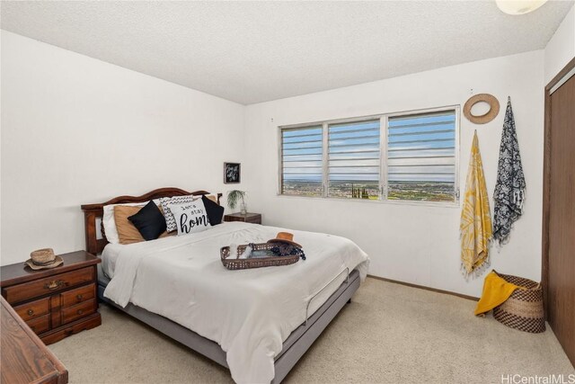 carpeted bedroom with baseboards and a textured ceiling