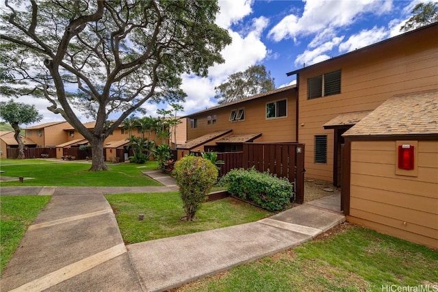 surrounding community with a residential view and a yard