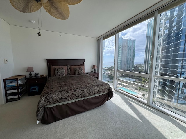 88 Piikoi St Unit 1802, Honolulu, HI 96814 - carpeted bedroom with a city view, a wall of windows, and ceiling fan