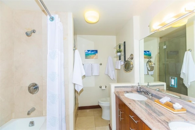 full bathroom featuring double vanity, baseboards, toilet, tile patterned floors, and a sink