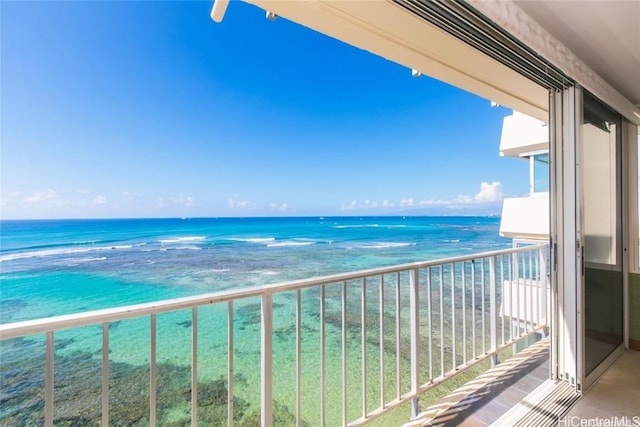 balcony with a water view and a beach view