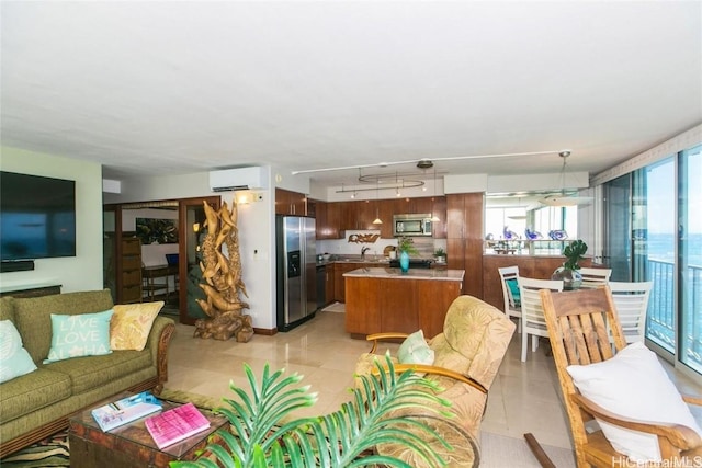 living area featuring an AC wall unit, rail lighting, and light tile patterned floors