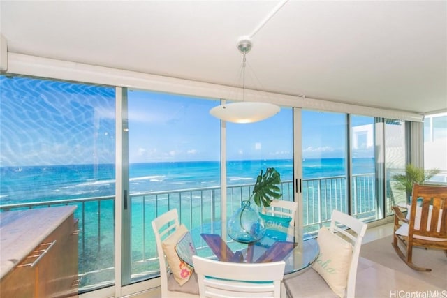 sunroom / solarium featuring a water view