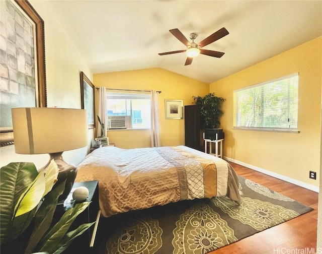 bedroom with ceiling fan, baseboards, vaulted ceiling, and wood finished floors