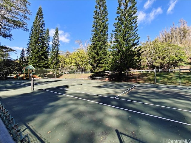 view of sport court with playground community and fence