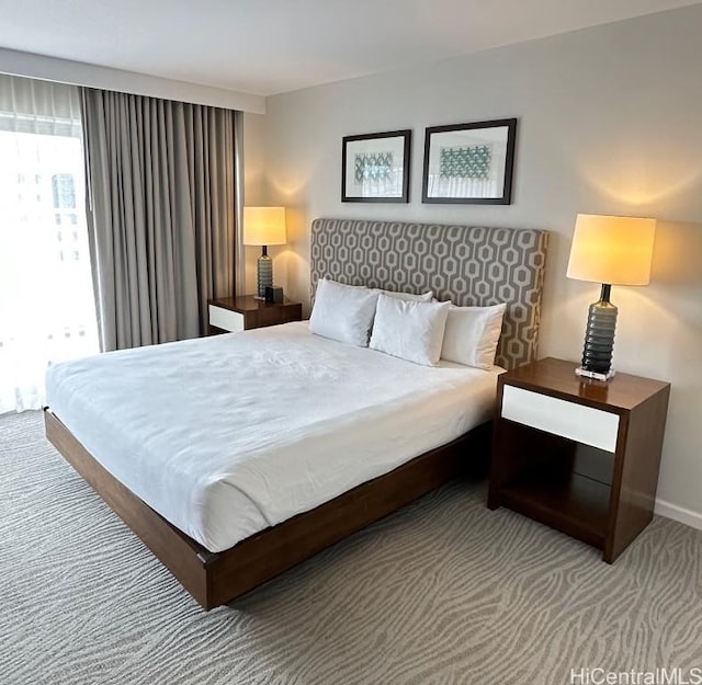 carpeted bedroom featuring baseboards