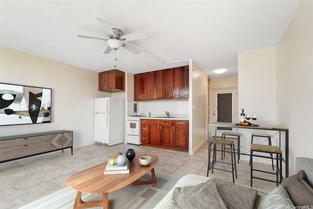 1550 Wilder Ave Unit A804, Honolulu, HI 96822 - living area with a ceiling fan, light tile patterned floors, and a textured ceiling