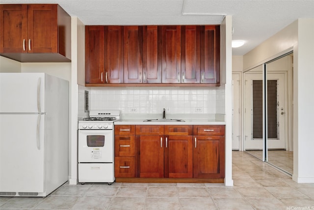 1550 Wilder Ave Unit A804, Honolulu, HI 96822 - kitchen featuring white appliances, light countertops, a sink, tasteful backsplash, and light tile patterned floors