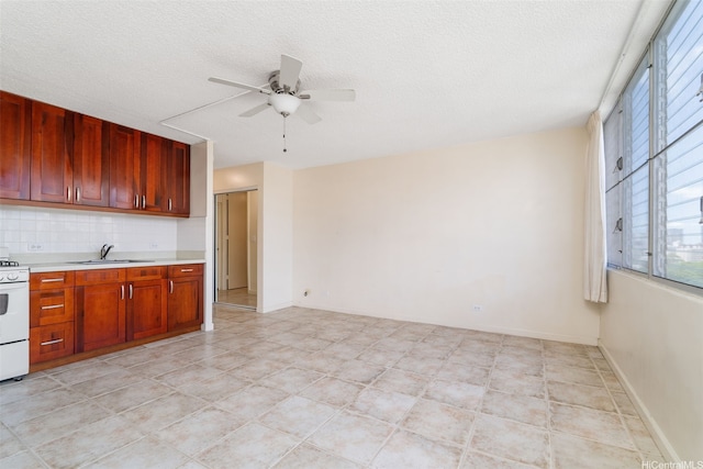 1550 Wilder Ave Unit A804, Honolulu, HI 96822 - kitchen featuring a ceiling fan, light countertops, a sink, electric stove, and tasteful backsplash